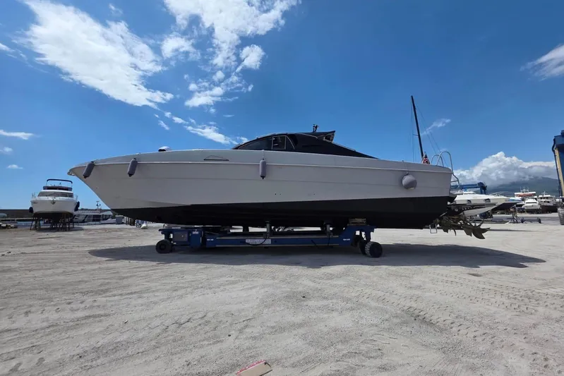  Yacht Photos Pics 1998 Otam 55 Millenium yacht on dry dock under a clear blue sky.