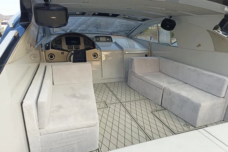  Yacht Photos Pics Interior of 1998 Otam 55 Millenium yacht with modern seating and control panel.