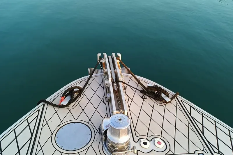  Yacht Photos Pics Bow of 1998 Otam 55 Millenium yacht with ropes and calm blue water.