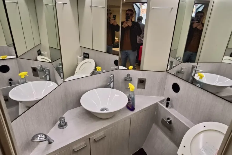  Yacht Photos Pics Bathroom interior of 1998 Otam 55 Millenium yacht with modern fixtures and mirrors.