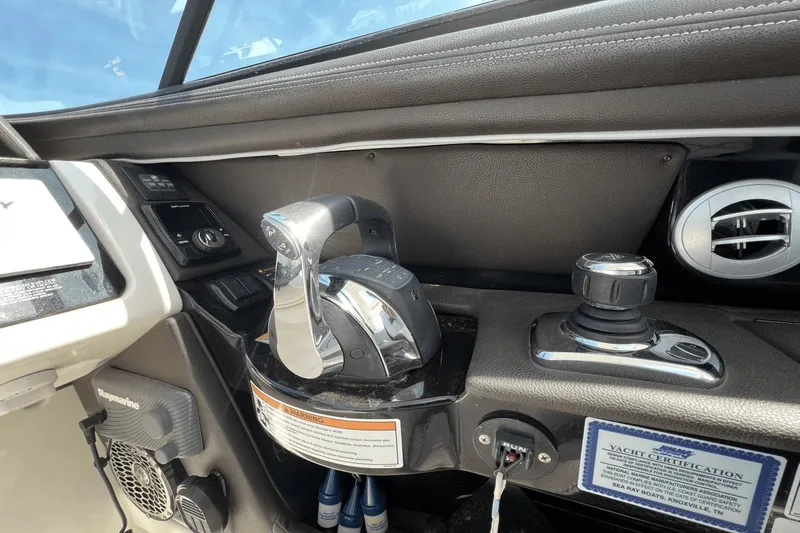  Yacht Photos Pics Control panel of a 2017 Sea Ray SLX 350 Outboard boat with throttle and joystick.