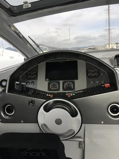  Yacht Photos Pics Cockpit of a 1998 Otam 55 Millenium yacht with steering wheel and control panel.