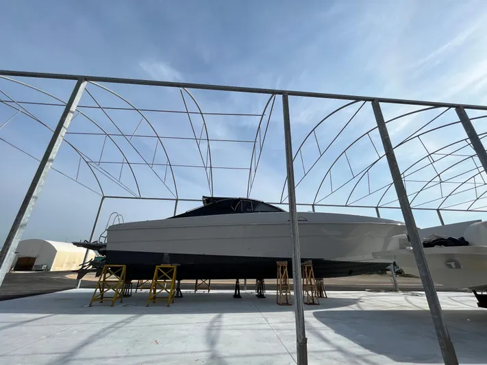  Yacht Photos Pics Otam 55 Millenium 1998 yacht under construction in a shipyard with a clear sky backdrop.