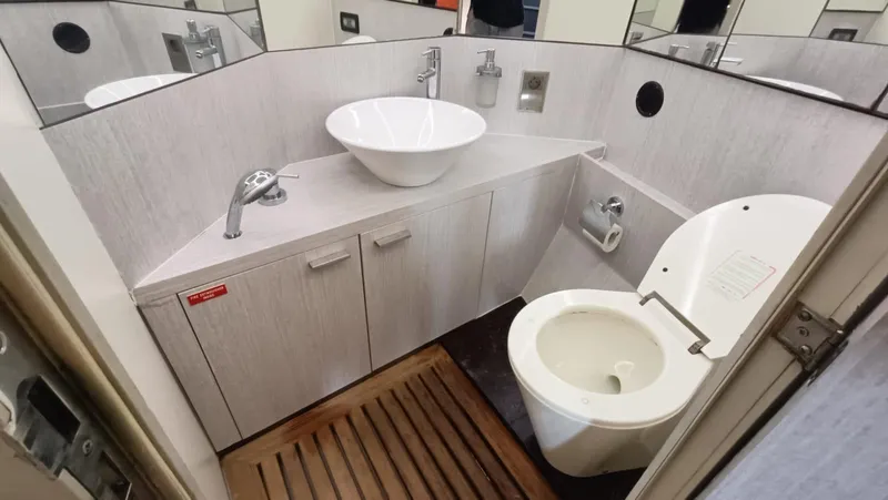  Yacht Photos Pics Luxurious bathroom in a 1998 Otam 55 Millenium yacht with modern fixtures and wooden flooring.