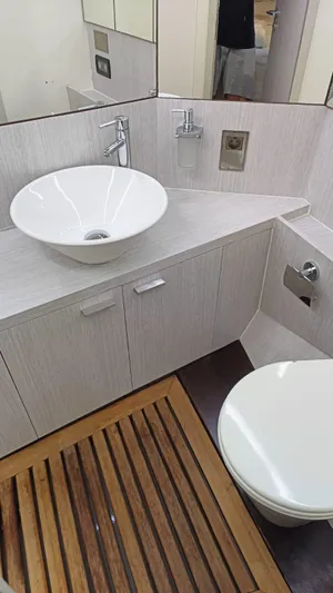  Yacht Photos Pics Bathroom interior of 1998 Otam 55 Millenium yacht with modern sink and wooden floor.
