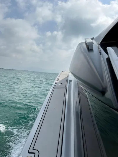  Yacht Photos Pics Otam 55 Millenium yacht cruising on open water under a cloudy sky.