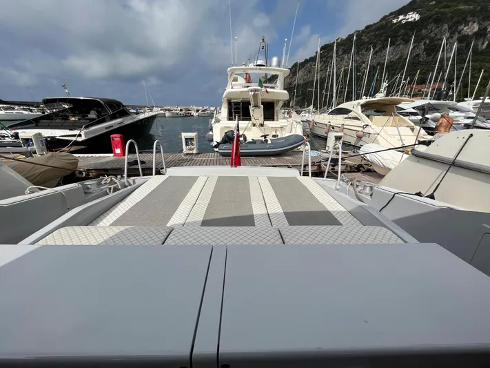  Yacht Photos Pics Otam 55 Millenium yacht docked at marina, surrounded by other boats, under cloudy sky.