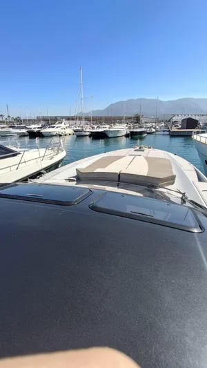  Yacht Photos Pics 1998 Otam 55 Millenium yacht docked in a marina with clear blue skies.