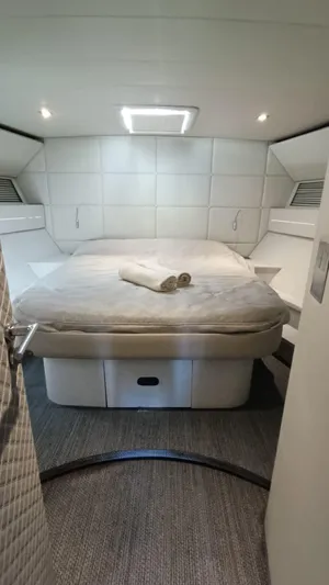  Yacht Photos Pics Luxurious cabin interior of 1998 Otam 55 Millenium yacht with cozy bed and modern lighting.