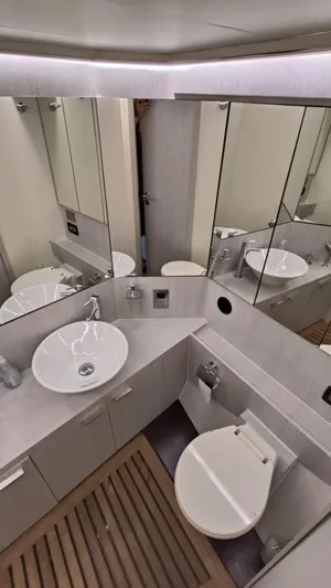  Yacht Photos Pics Bathroom interior of 1998 Otam 55 Millenium yacht with modern fixtures and mirrored cabinets.