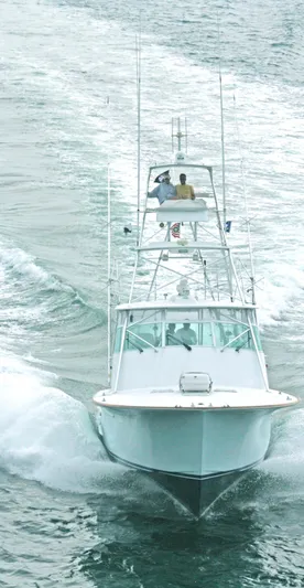 Waterproof Yacht Photos Pics 2001 Davis 45 Express boat cruising on open water, viewed from the front.