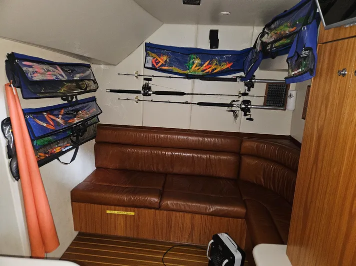 Waterproof Yacht Photos Pics Interior of 2001 Davis 45 Express boat with fishing rods and leather seating.