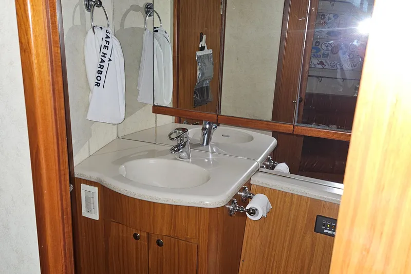 Waterproof Yacht Photos Pics Bathroom interior of 2001 Davis 45 Express yacht with dual sinks and wooden cabinetry.