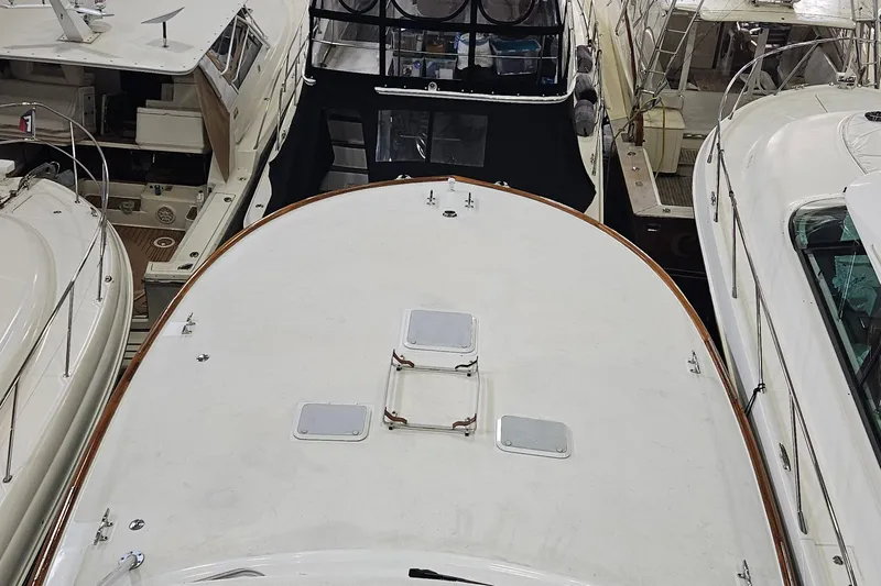 Waterproof Yacht Photos Pics 2001 Davis 45 Express yacht docked among other boats in a marina.