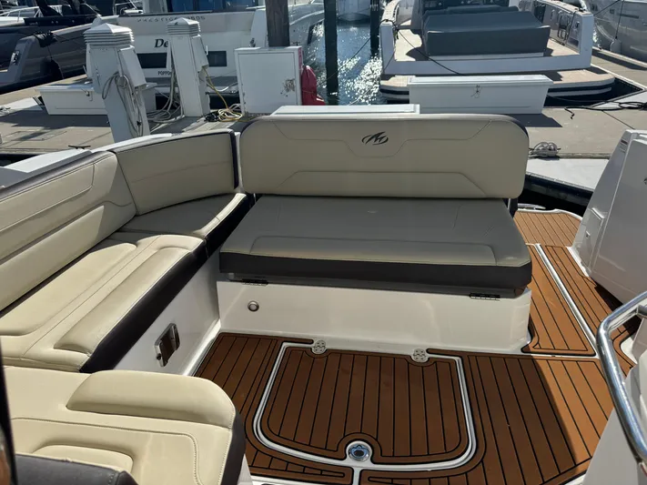 Kaja Yacht Photos Pics 2018 Monterey 335 SY boat interior with beige seating and teak flooring at a marina.