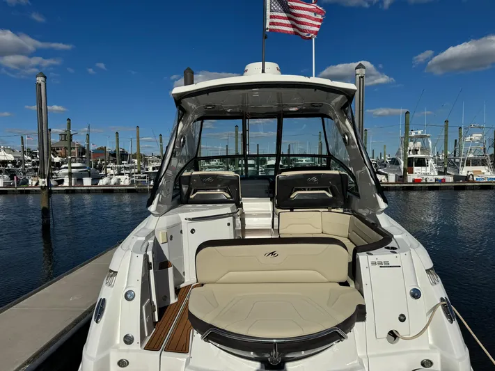 Kaja Yacht Photos Pics 2018 Monterey 335 SY boat docked at marina, American flag waving, clear blue sky.