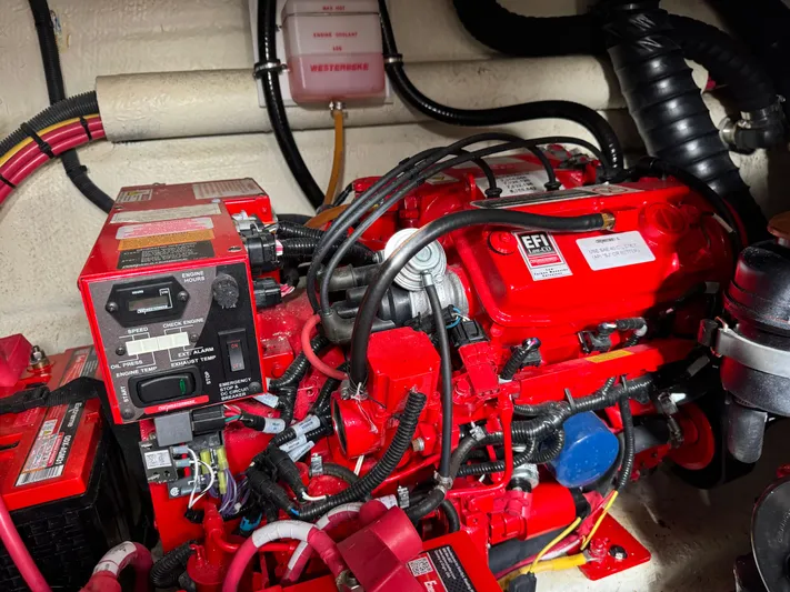 Kaja Yacht Photos Pics Engine compartment of a 2018 Monterey 335 SY boat, featuring red EFI engine components.