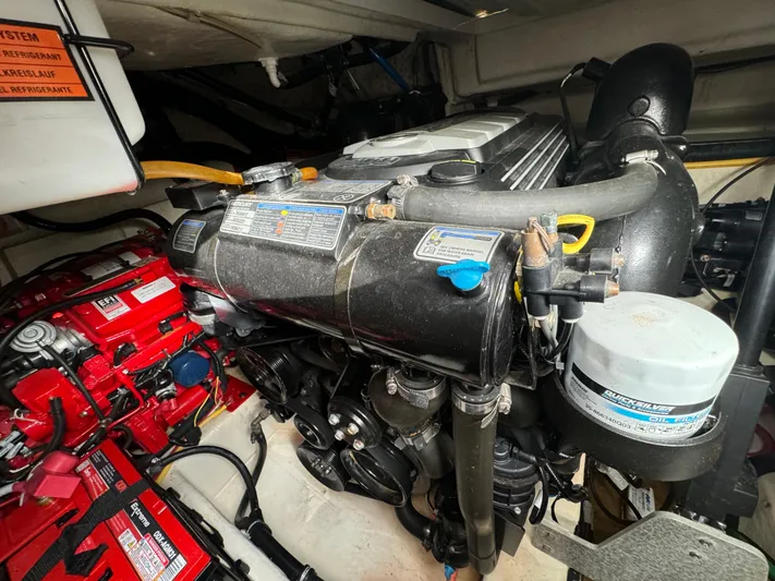 Kaja Yacht Photos Pics Engine compartment of a 2018 Monterey 335 SY boat, showcasing mechanical components and battery setup.