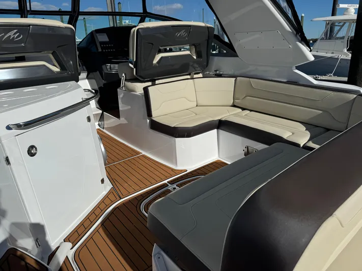 Kaja Yacht Photos Pics 2018 Monterey 335 SY boat interior with beige seating and wood flooring.