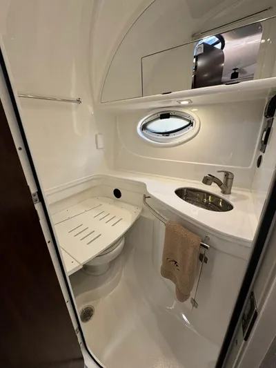 Kaja Yacht Photos Pics 2018 Monterey 335 SY boat bathroom with sink, mirror, and porthole window.