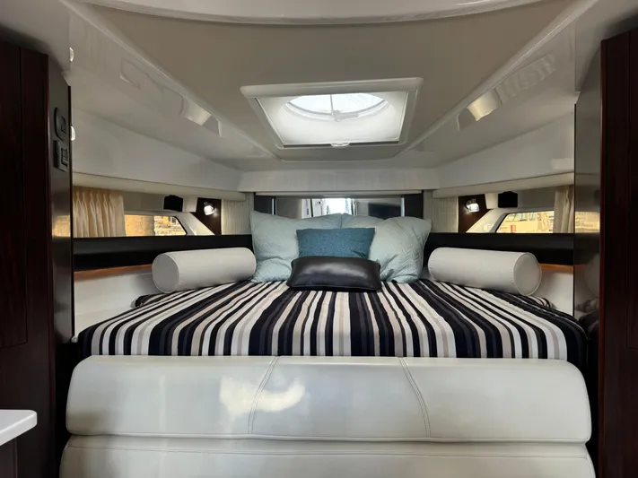 Kaja Yacht Photos Pics Luxurious interior of 2018 Monterey 335 SY yacht with striped bedding and skylight.