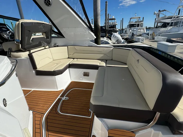 Kaja Yacht Photos Pics 2018 Monterey 335 SY boat with spacious seating and teak flooring at a marina.