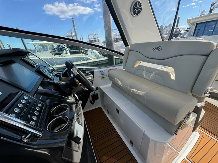 Kaja Yacht Photos Pics 2018 Monterey 335 SY yacht interior with helm, seating, and modern controls.