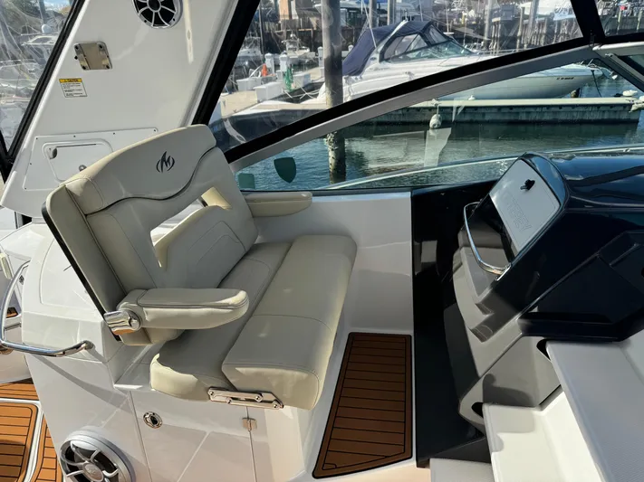 Kaja Yacht Photos Pics 2018 Monterey 335 SY boat interior with helm seat and dashboard, docked at marina.