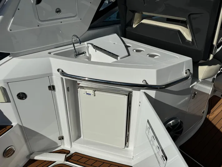 Kaja Yacht Photos Pics 2018 Monterey 335 SY yacht kitchenette with sink, storage, and cup holders.