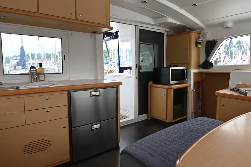  Yacht Photos Pics Interior of 2009 Lagoon 440 catamaran with modern kitchen and dining area.