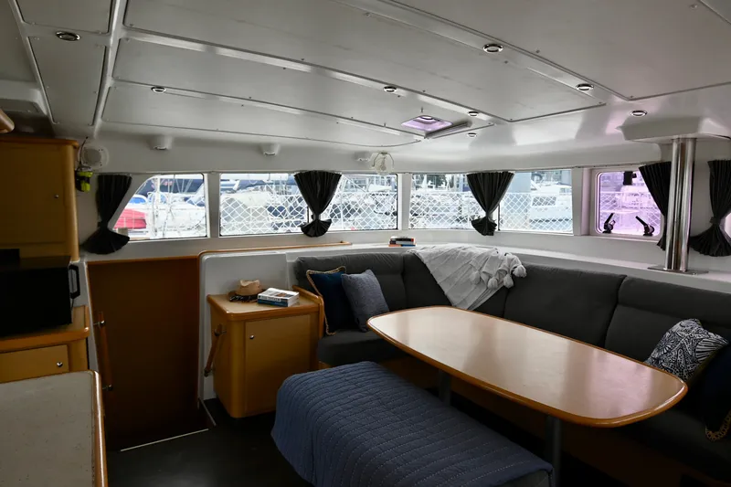  Yacht Photos Pics Interior of 2009 Lagoon 440 catamaran with cozy seating and dining area.