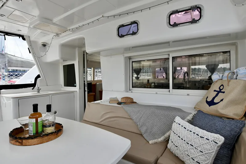  Yacht Photos Pics Interior of 2009 Lagoon 440 catamaran with cozy seating and nautical decor.