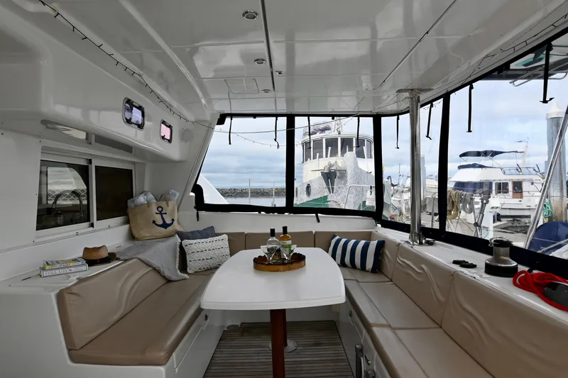  Yacht Photos Pics Interior of 2009 Lagoon 440 catamaran with cozy seating and nautical decor.