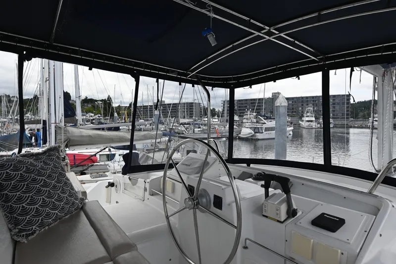  Yacht Photos Pics Interior view of 2009 Lagoon 440 catamaran helm, overlooking marina with docked boats.