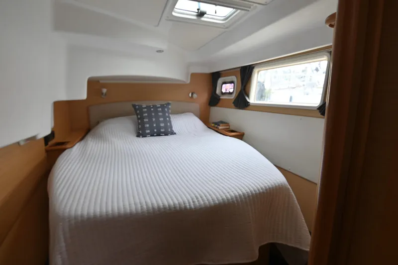  Yacht Photos Pics Cozy bedroom in 2009 Lagoon 440 yacht with a large bed and window views.