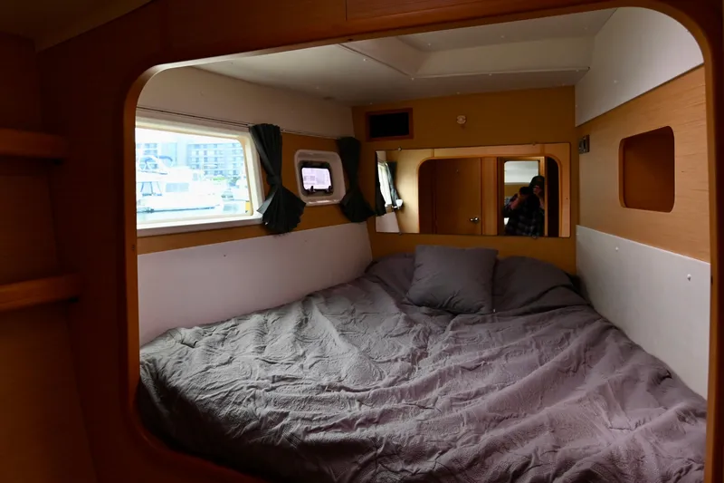  Yacht Photos Pics Cozy cabin interior of 2009 Lagoon 440 catamaran with bed and windows.