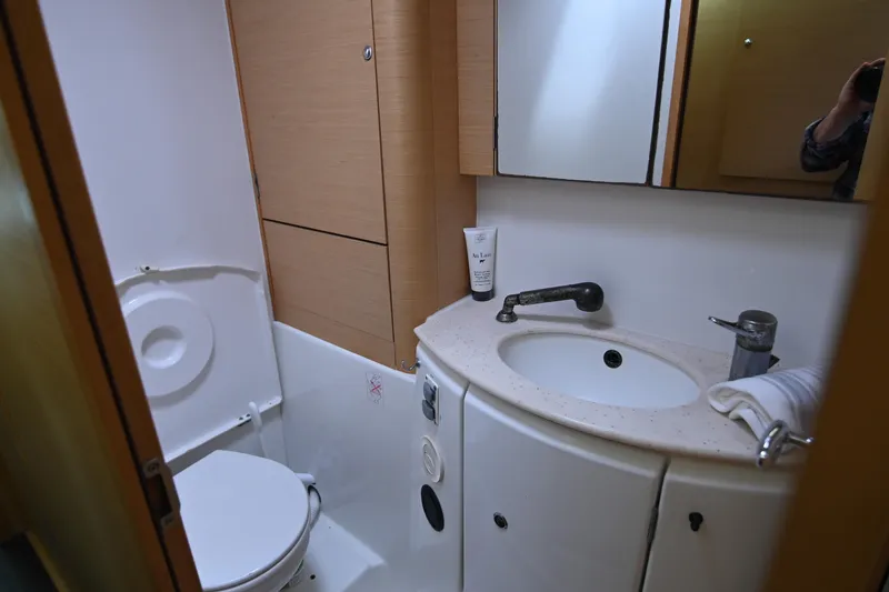  Yacht Photos Pics Compact bathroom in a 2009 Lagoon 440 yacht with sink, toilet, and storage.