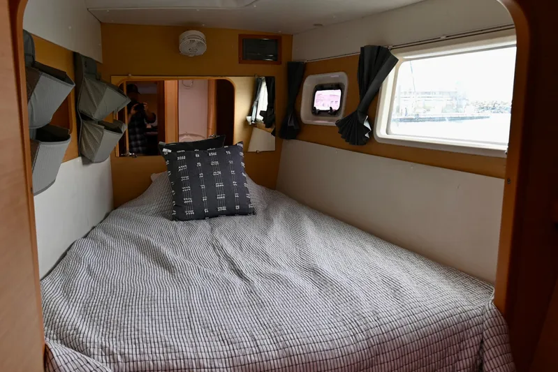  Yacht Photos Pics Cozy cabin interior of 2009 Lagoon 440 catamaran with bed and window view.