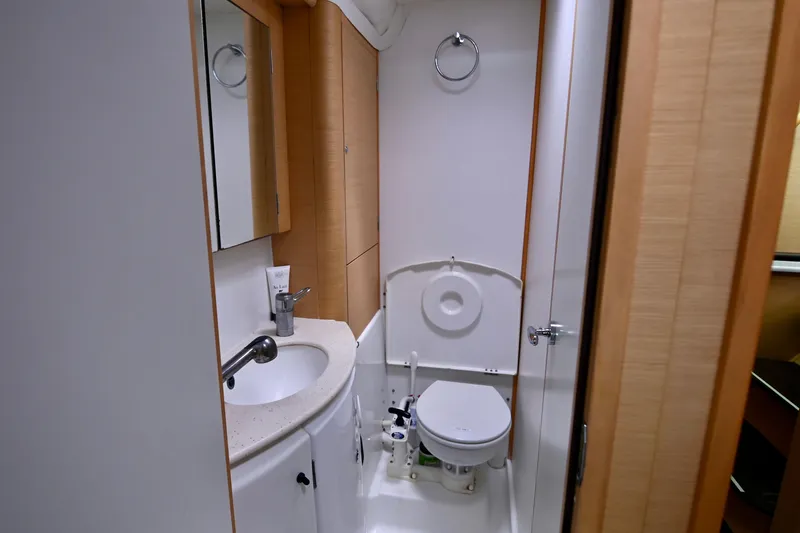  Yacht Photos Pics Bathroom interior of 2009 Lagoon 440 yacht, featuring sink, mirror, and toilet.