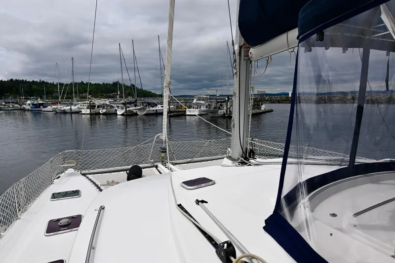  Yacht Photos Pics Lagoon 440 catamaran from 2009 docked in a marina with overcast skies.