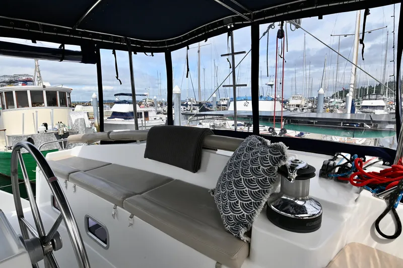  Yacht Photos Pics Lagoon 440 catamaran cockpit view, 2009 model, with marina background and comfortable seating.