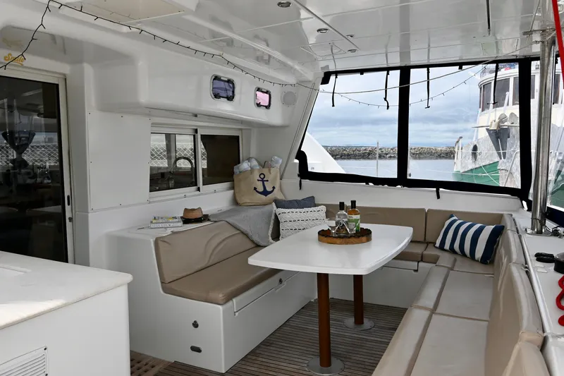  Yacht Photos Pics Interior of 2009 Lagoon 440 catamaran with cozy seating and nautical decor.