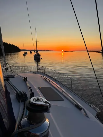  Yacht Photos Pics Lagoon 440 sailboat at sunset on calm waters, 2009 model.
