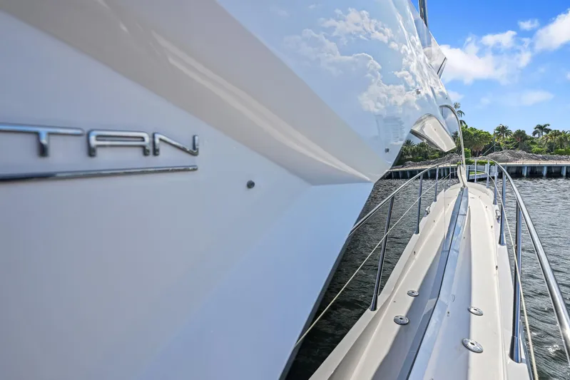  Yacht Photos Pics 2020 Sunseeker Manhattan 52 yacht, sleek design, docked by waterfront, clear blue sky.