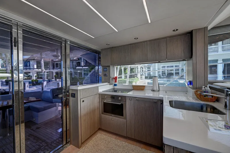  Yacht Photos Pics Modern kitchen interior on a 2020 Sunseeker Manhattan 52 yacht, featuring sleek cabinetry and appliances.