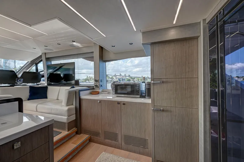 Yacht Photos Pics Luxurious interior of 2020 Sunseeker Manhattan 52 yacht with modern kitchen and seating area.
