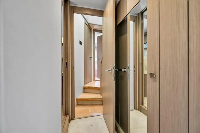  Yacht Photos Pics Interior hallway of 2020 Sunseeker Manhattan 52 yacht with wooden doors and steps.