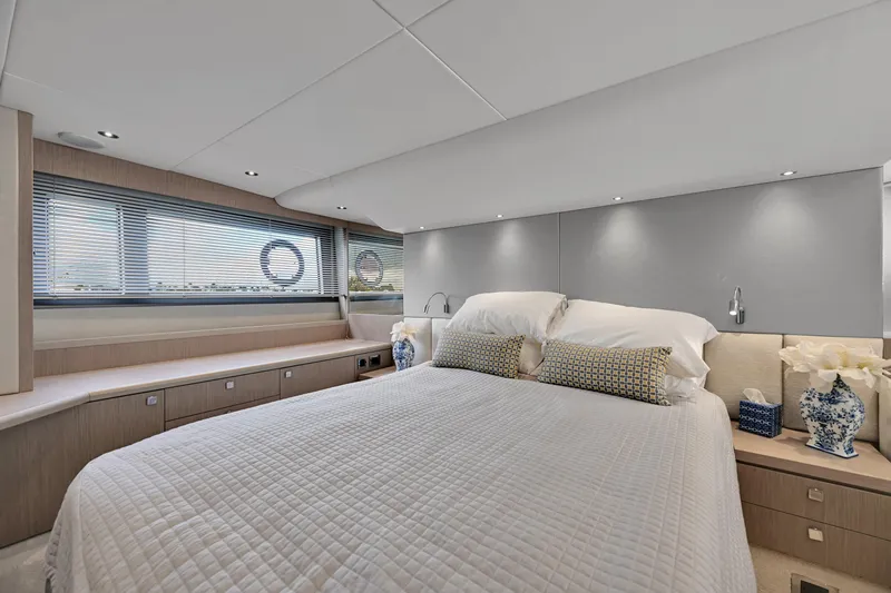  Yacht Photos Pics Luxurious bedroom interior of 2020 Sunseeker Manhattan 52 yacht, featuring elegant decor and ample natural light.