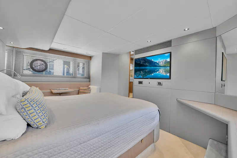  Yacht Photos Pics Luxurious Sunseeker Manhattan 52 yacht bedroom interior, featuring modern design and a large TV, 2020 model.