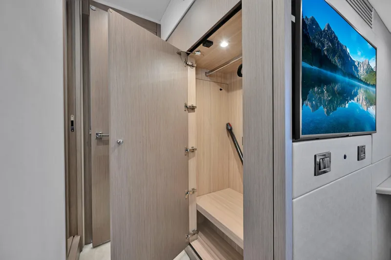  Yacht Photos Pics Interior of 2020 Sunseeker Manhattan 52 yacht with open storage and wall-mounted TV.